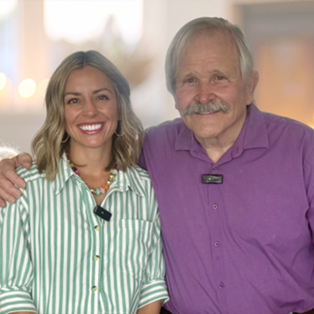 Jim and Robin standing together with a blurred background
