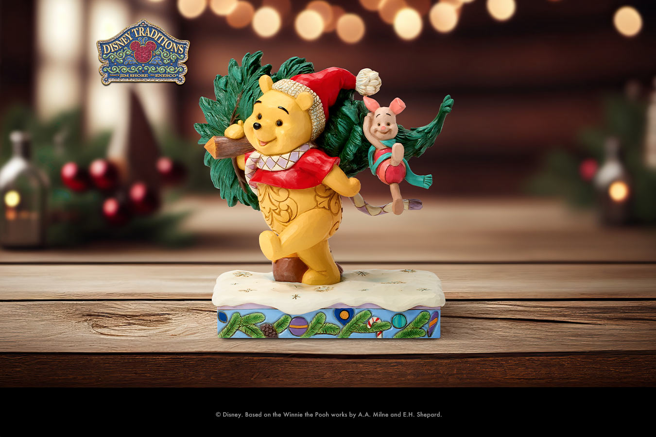 Christmas-themed figurine of a bear and a girl with a wreath on a wooden surface.