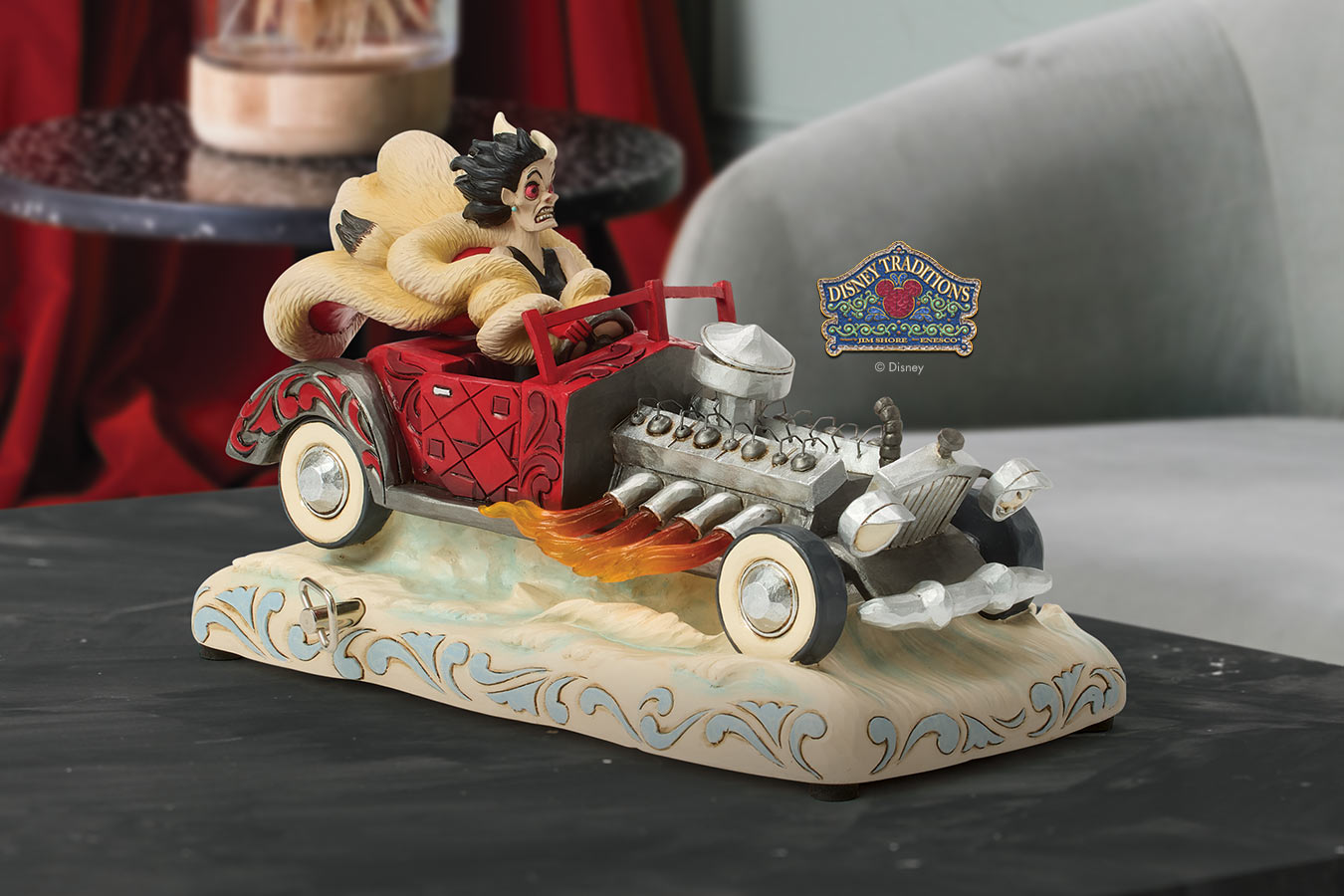 Decorative figurine of a character in a car with a 'Disney' logo in the background.