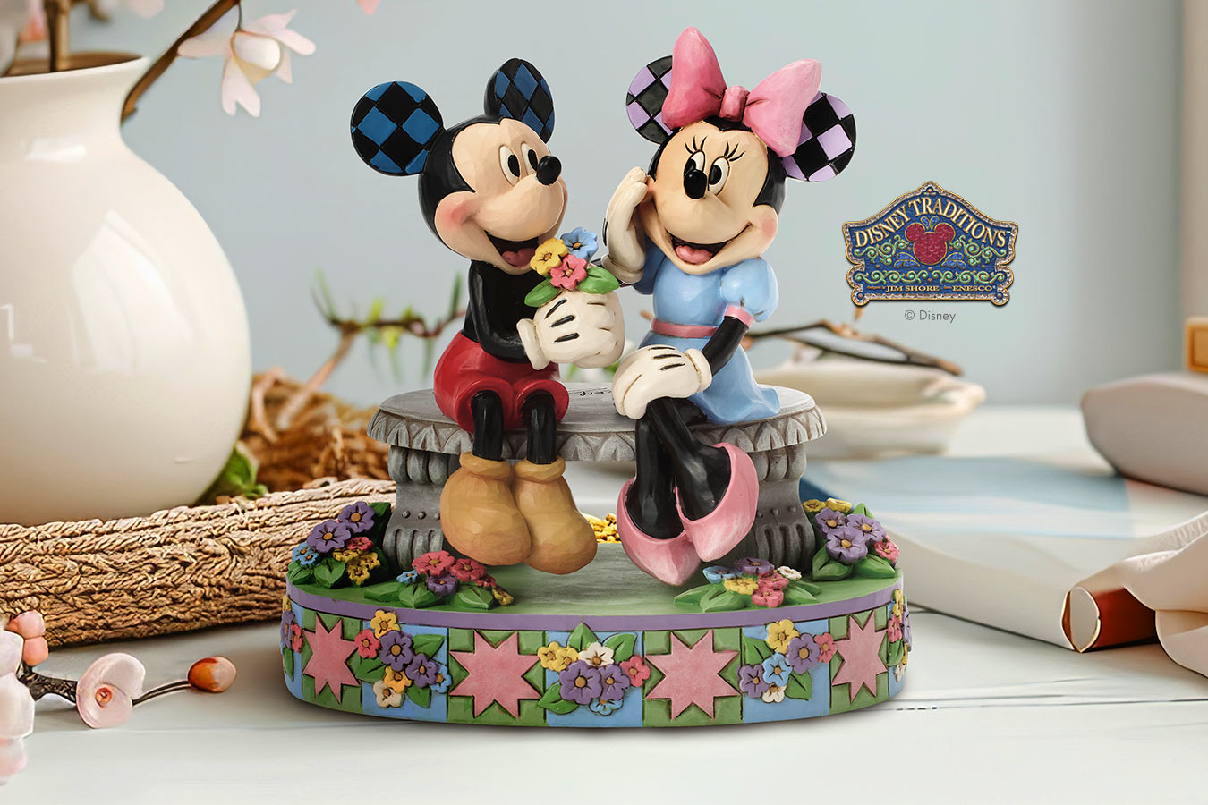 Mickey and Minnie Mouse figurine on a decorative base with 'Disney Traditions' logo.
