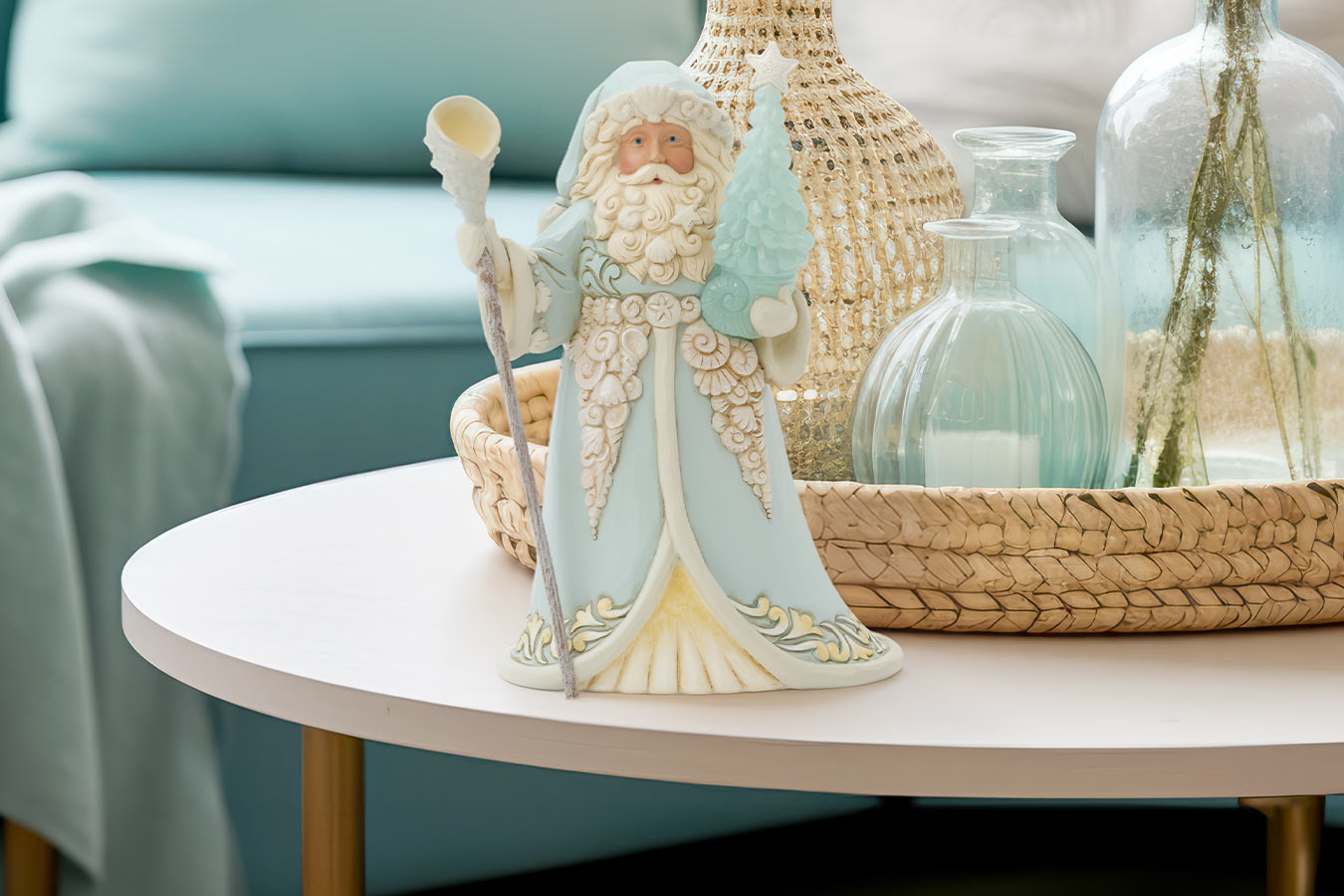 Decorative figurine of a bearded man in a light blue outfit on a table with decorative items.