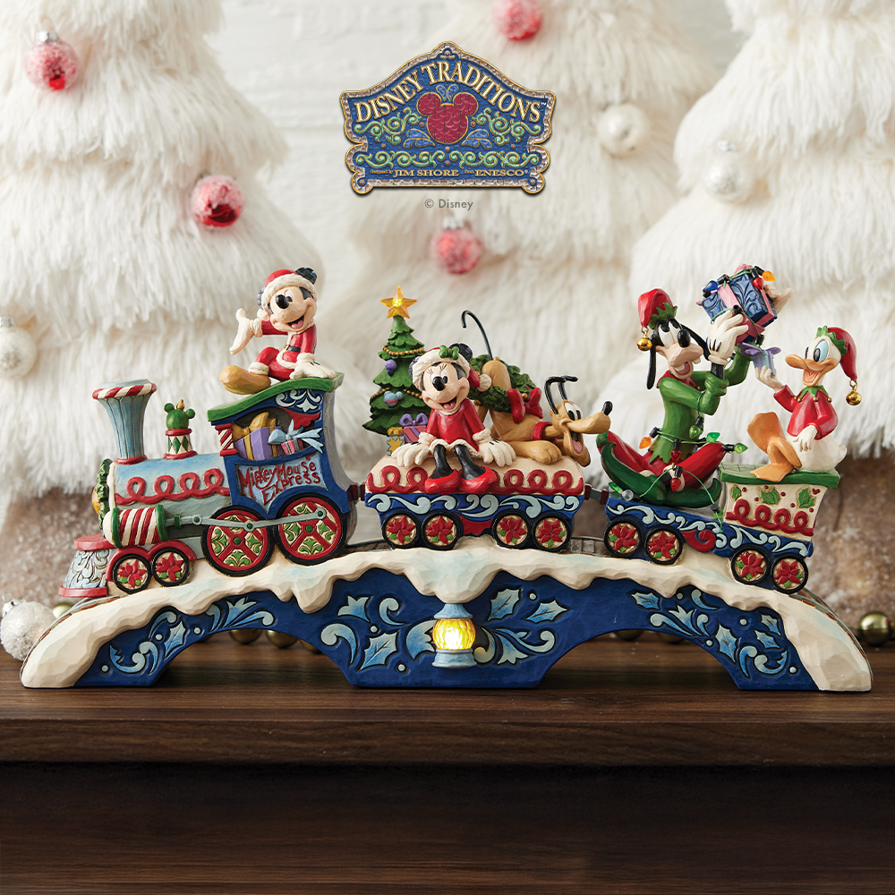 Decorative train set with Disney characters on a stand, featuring the Disney Traditions logo.