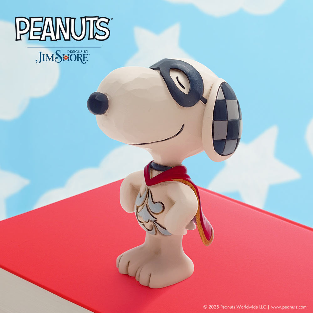 Snoopy figurine with superhero cape and mask on a red platform with star-shaped clouds in the background