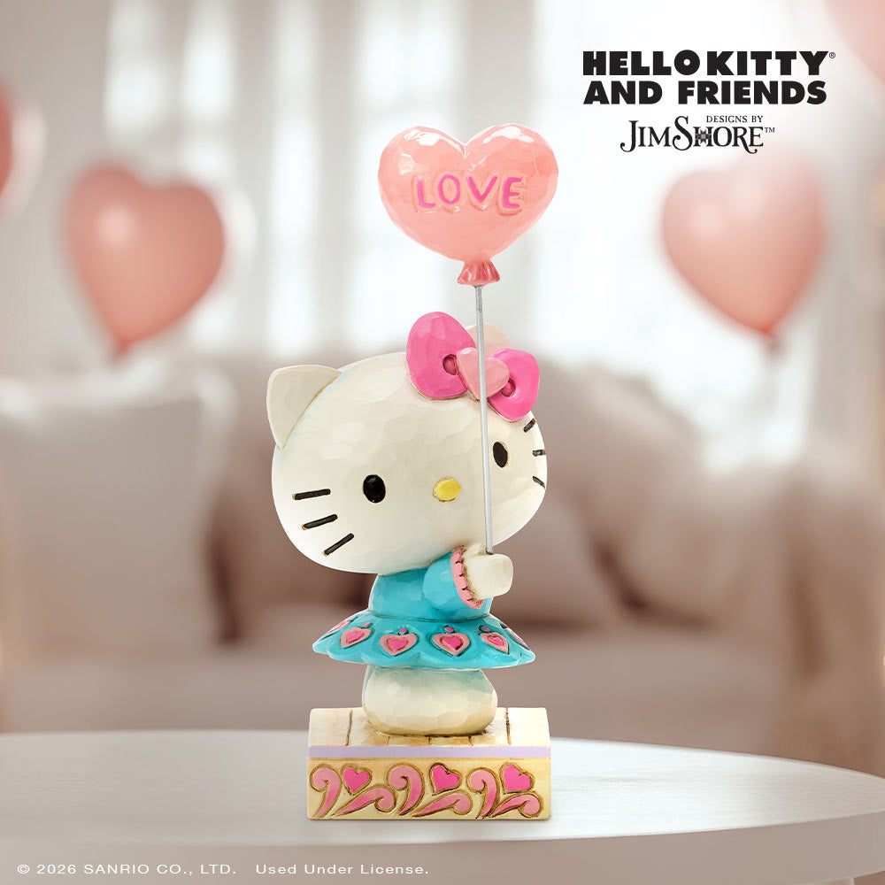 Hello Kitty figurine holding a 'LOVE' balloon with blurred balloons in the background