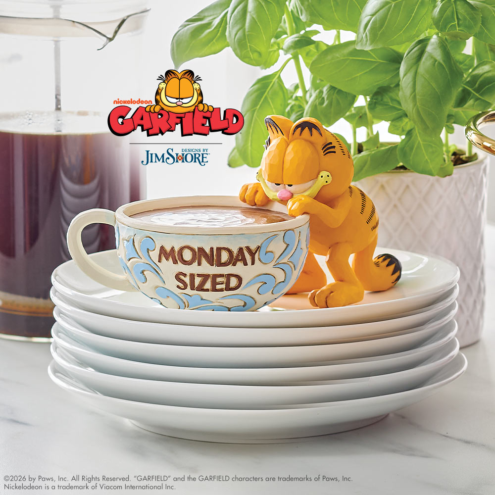 Garfield figurine with a 'Monday Sized' cup on a stack of plates, with Garfield logo in the background.