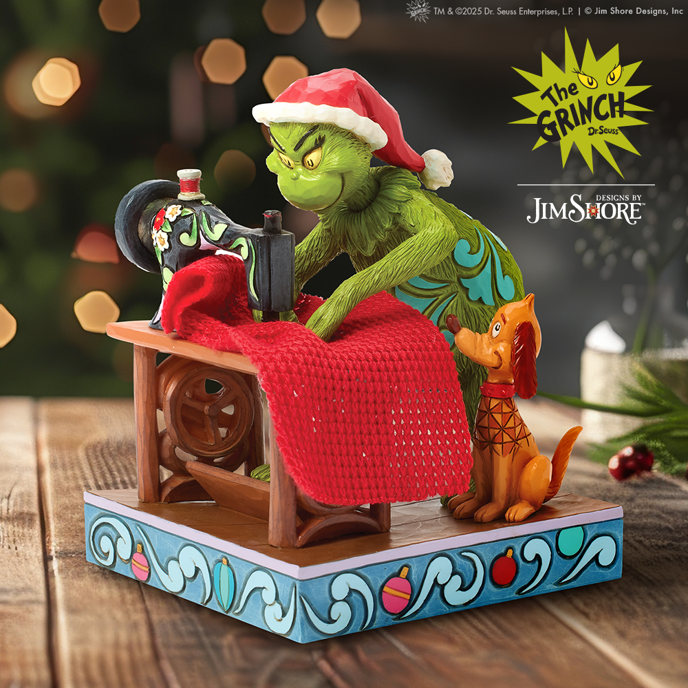 Decorative figurine of the Grinch and Max with a Christmas tree in the background