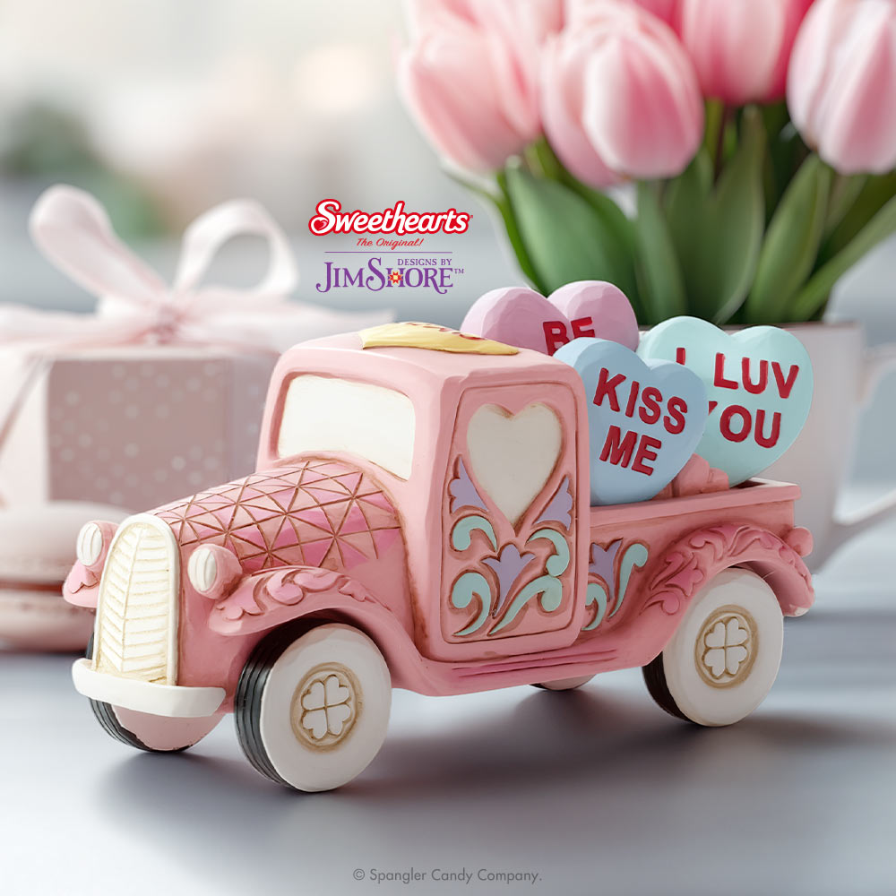 Pink toy truck with heart-shaped candy and 'Sweethearts' branding in the background.